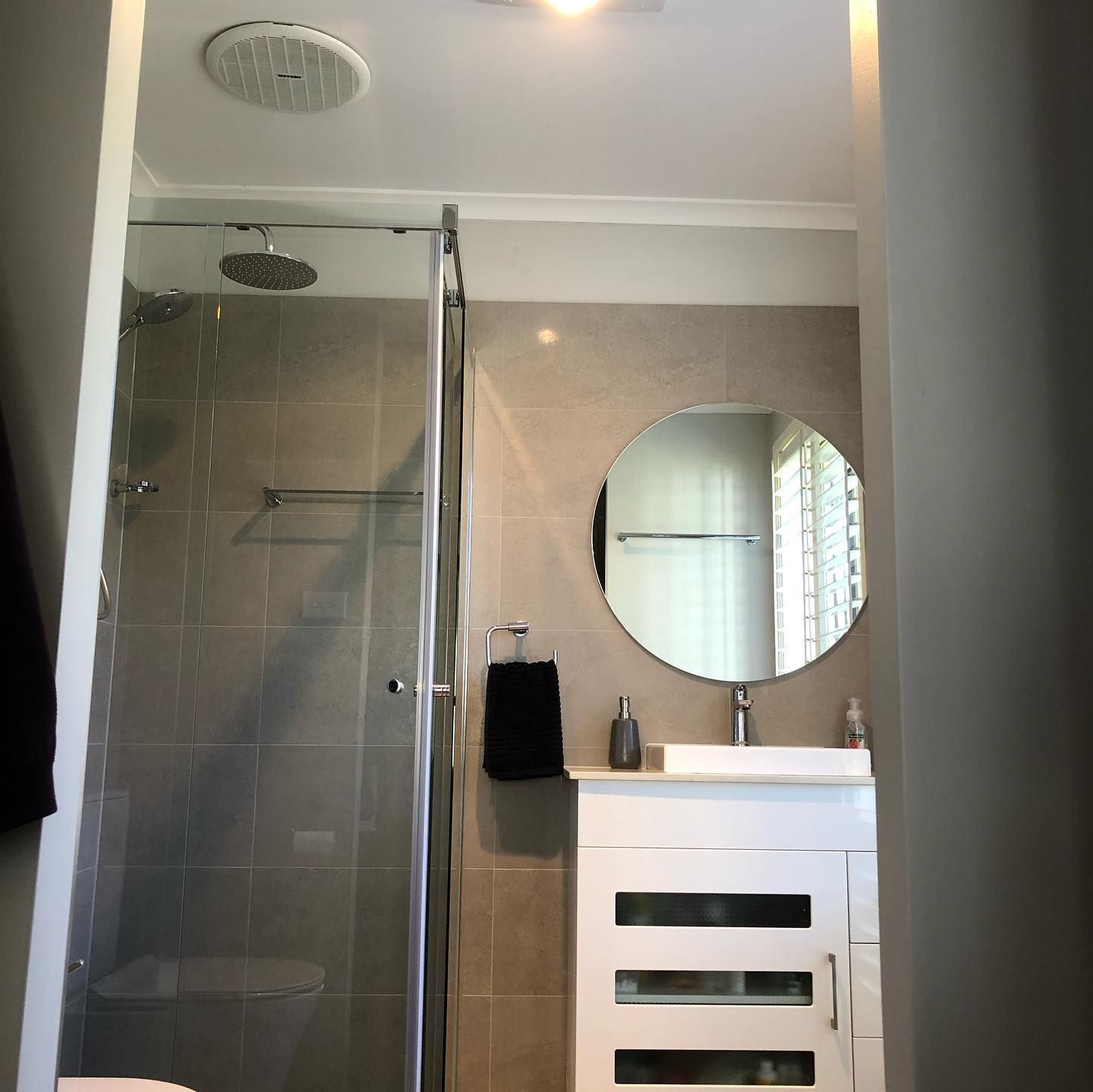 Bathroom With Shower, Vanity, and Round Mirror — JNR Building And Maintenance in Green Hill, QLD