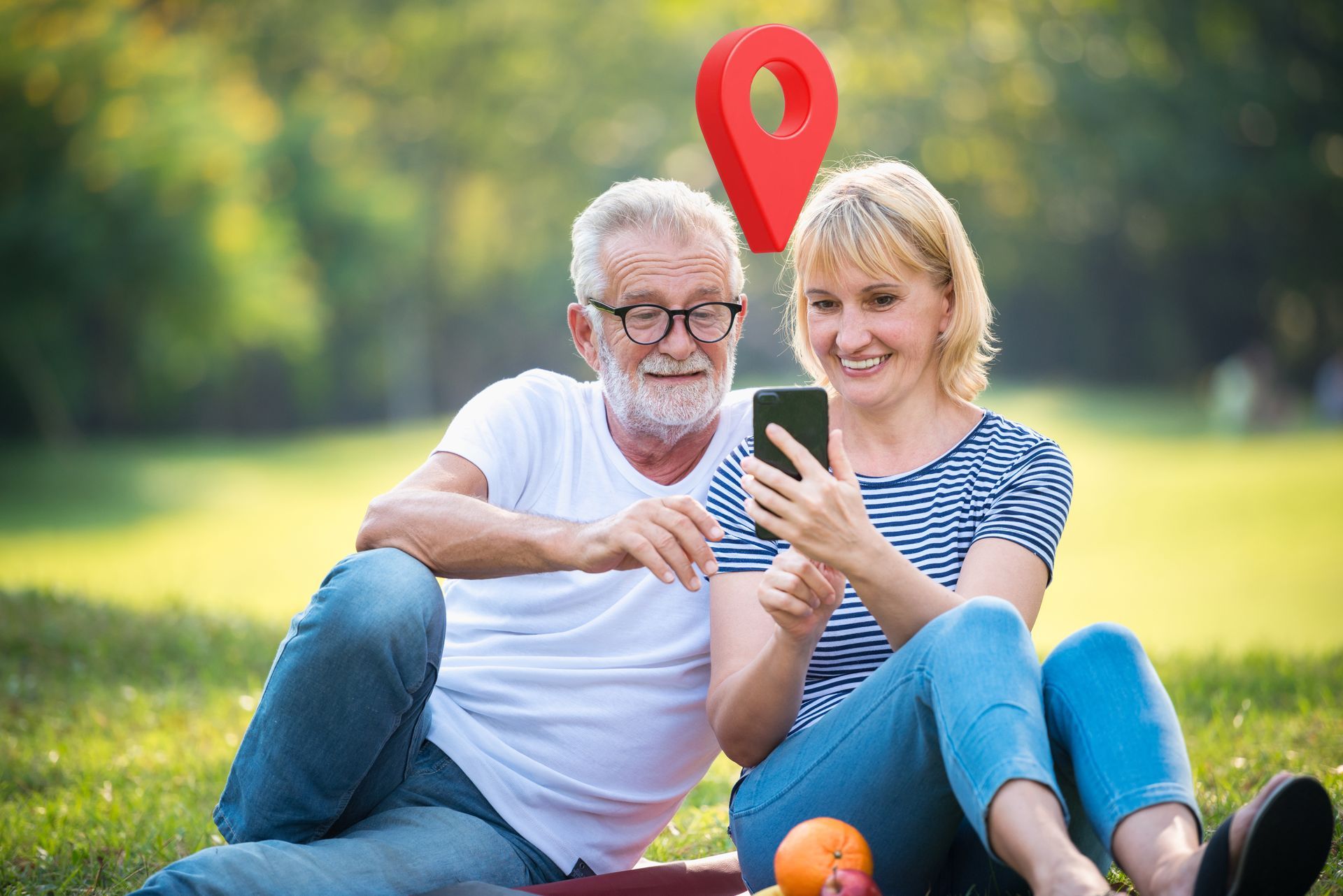 Couple in park, smiling, looking at smartphone with location marker overhead.
