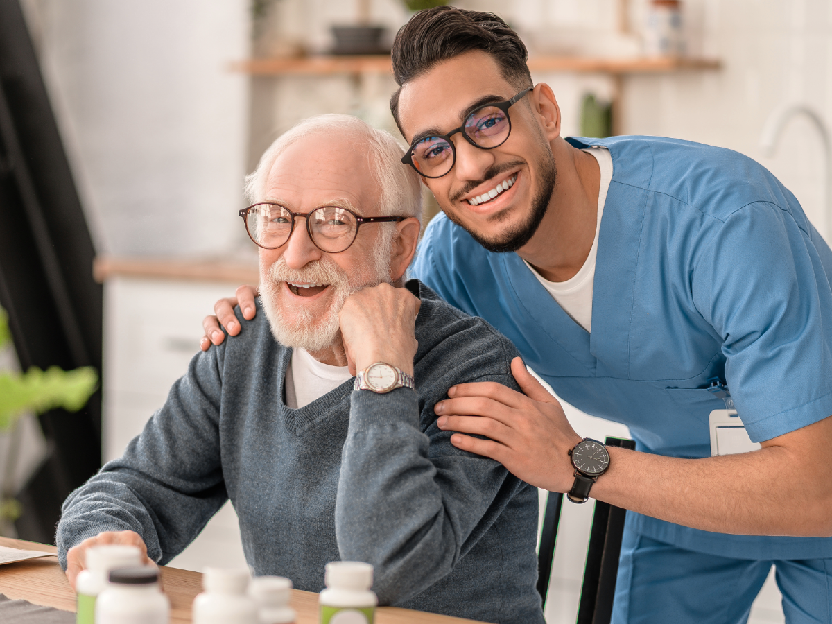 Older man at home with a healthcare professional providing clinical support. 