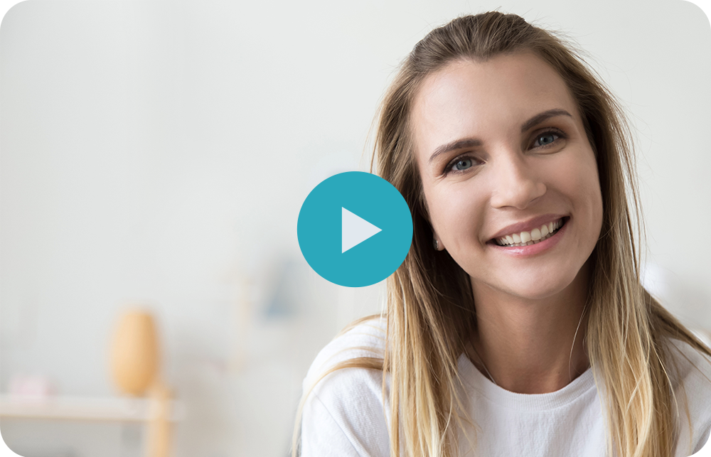 Smiling woman in a white shirt with a blue play button overlay, against a blurred indoor background