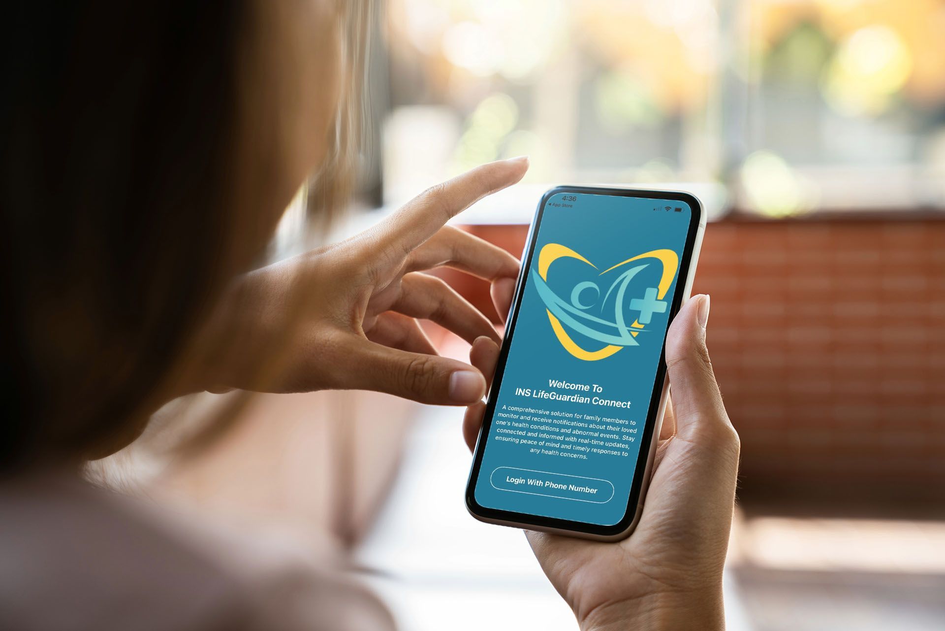 A woman is holding a cell phone in her hand.