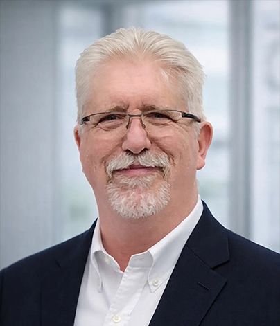 Professional headshot of Mark Price, a mature man with glasses and a navy suit, representing the trust and expertise of VP Insurance Services.