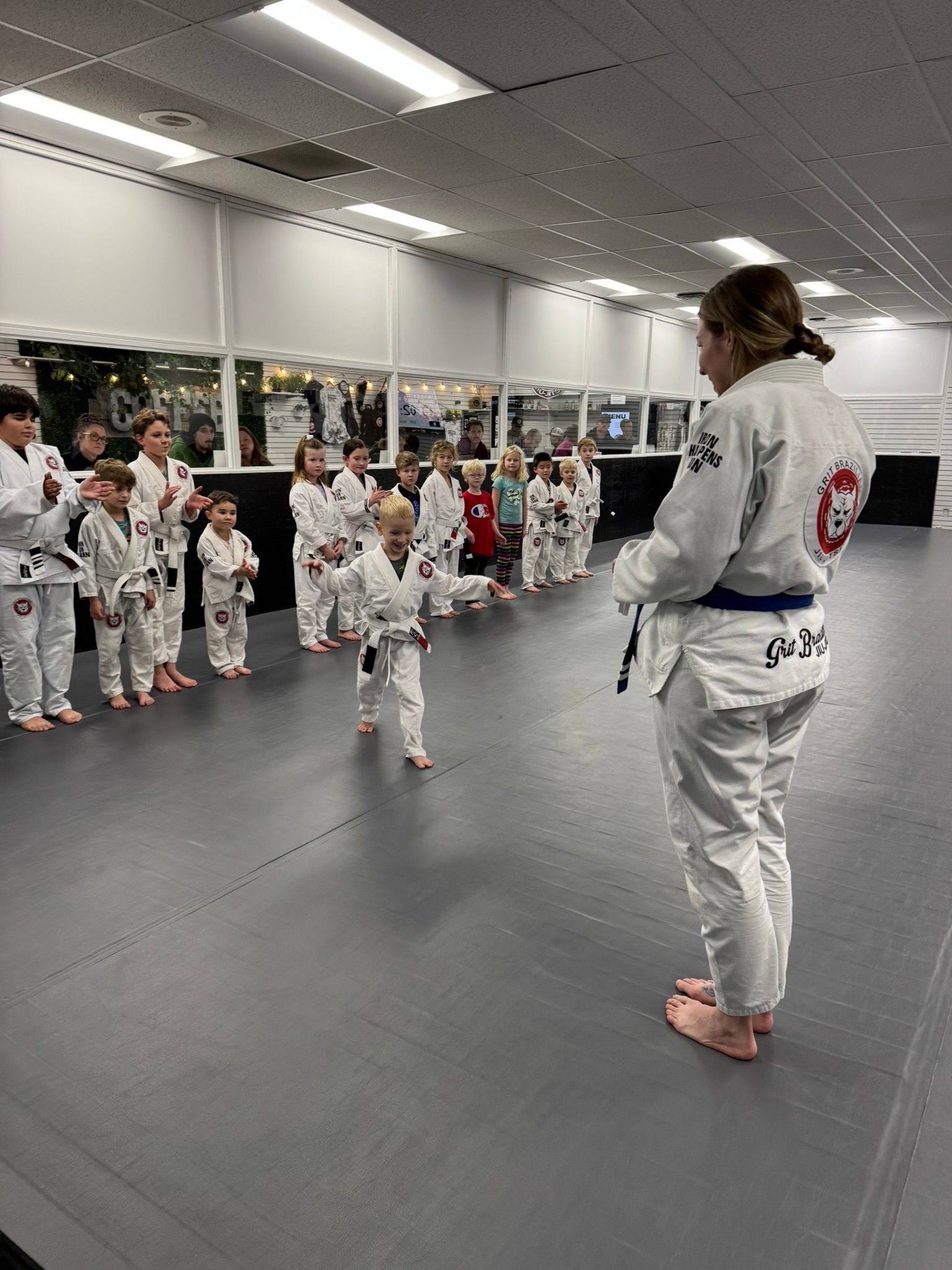 Kids practicing controlled grappling at Grit Jiu-Jitsu & Muay Thai Martial Arts in Spokane Valley, WA, building resilience.