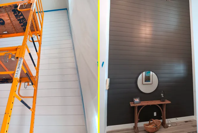 Orange lift beside a white wall; dark accent wall with round mirror and small wooden table.