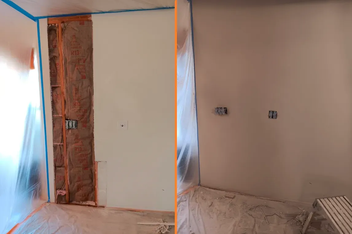 Partially renovated room with taped walls, exposed brick, and covered furniture under plastic sheeting