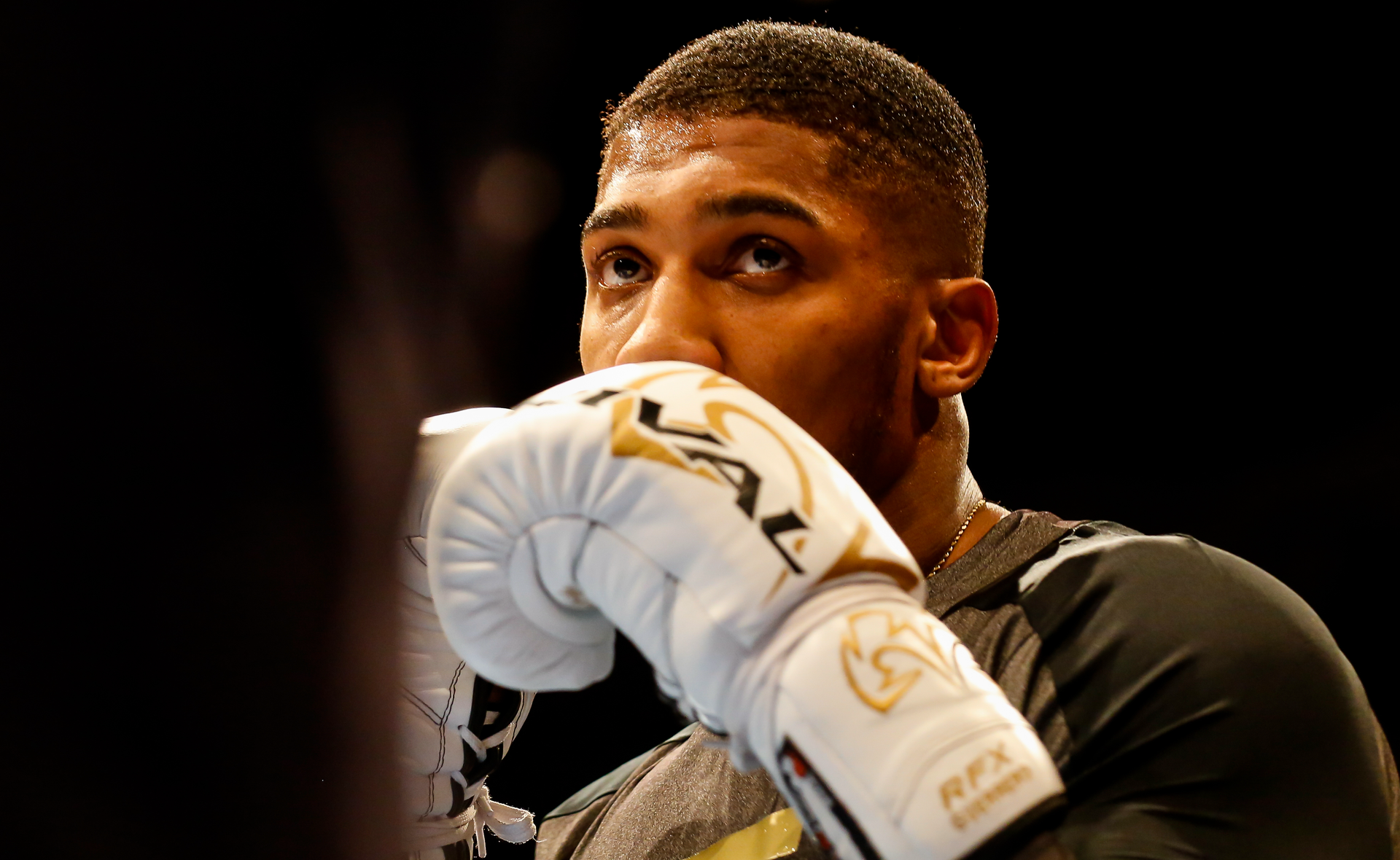 Anthony Joshua, poses confidently in training gear ahead of his fight against Daniel Dubois.