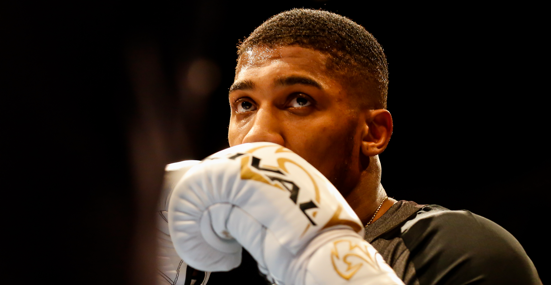 Anthony Joshua, renowned British heavyweight boxer, poses confidently in training gear ahead of his highly anticipated fight against Daniel Dubois at Wembley Stadium in 2024.