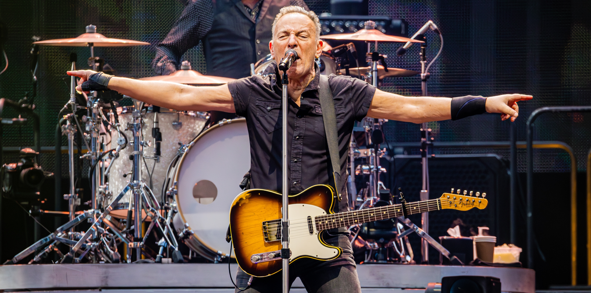 Bruce Springsteen performing live at Wembley Stadium, electrifying the crowd with their legendary rock music.