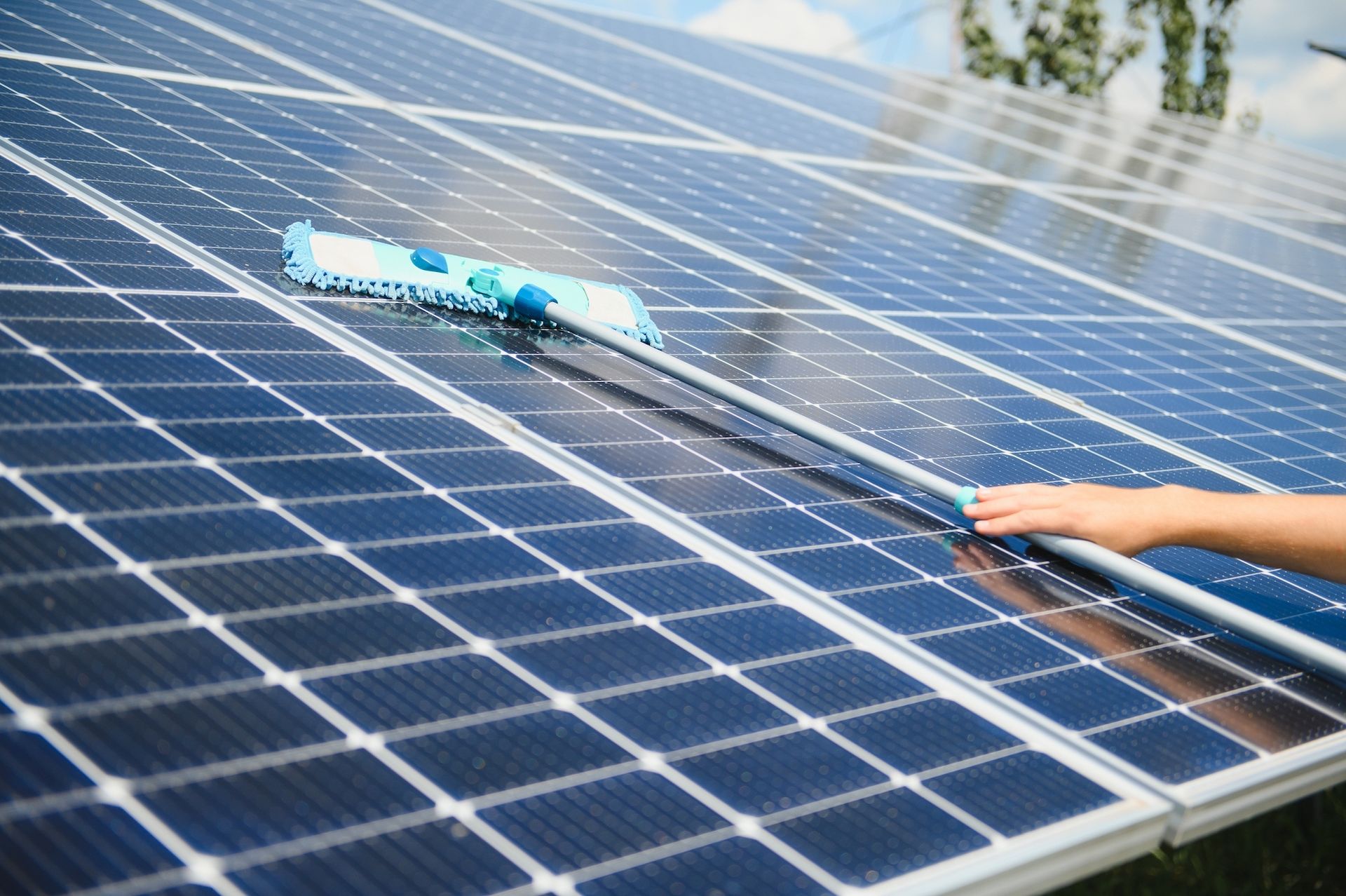 Cleaning solar panels with a brush outdoors