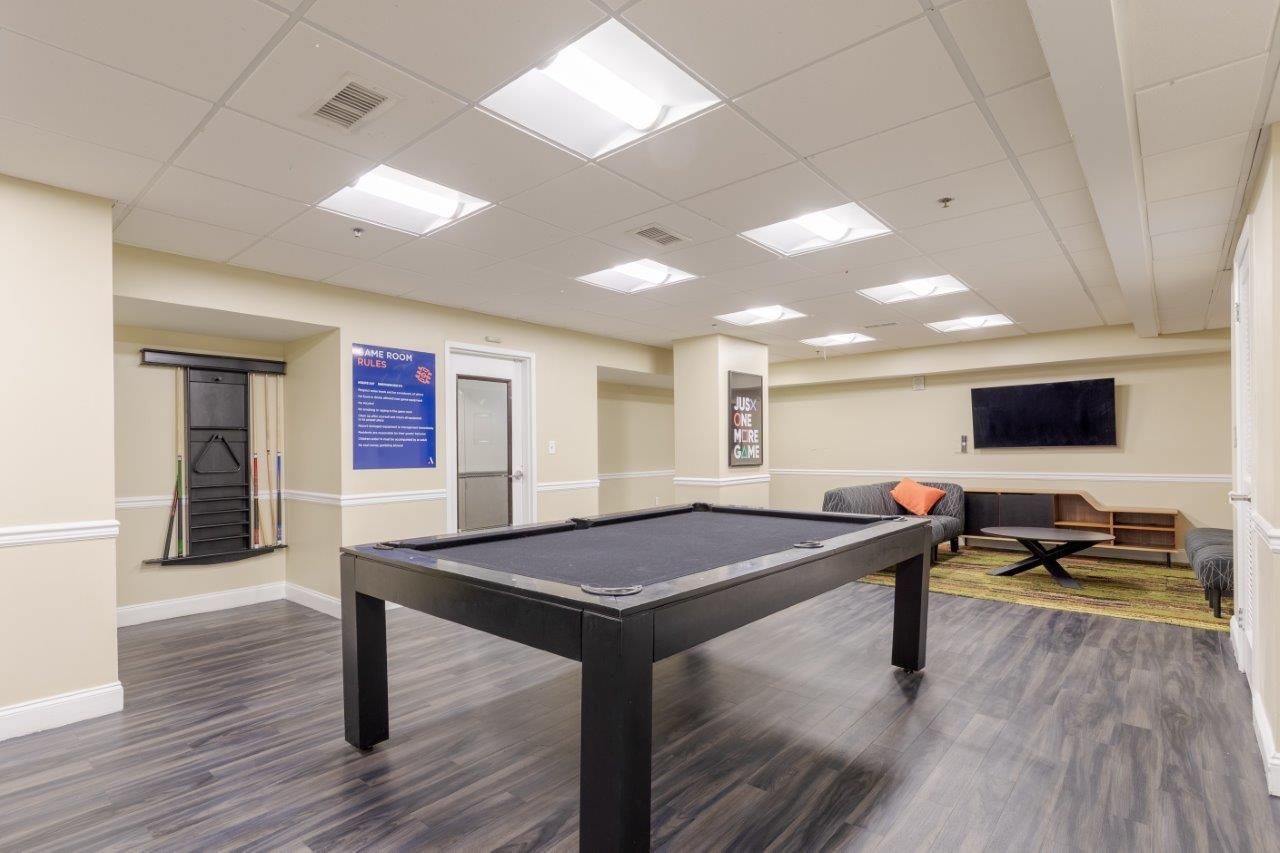 Recreation room with a pool table, TV, couches