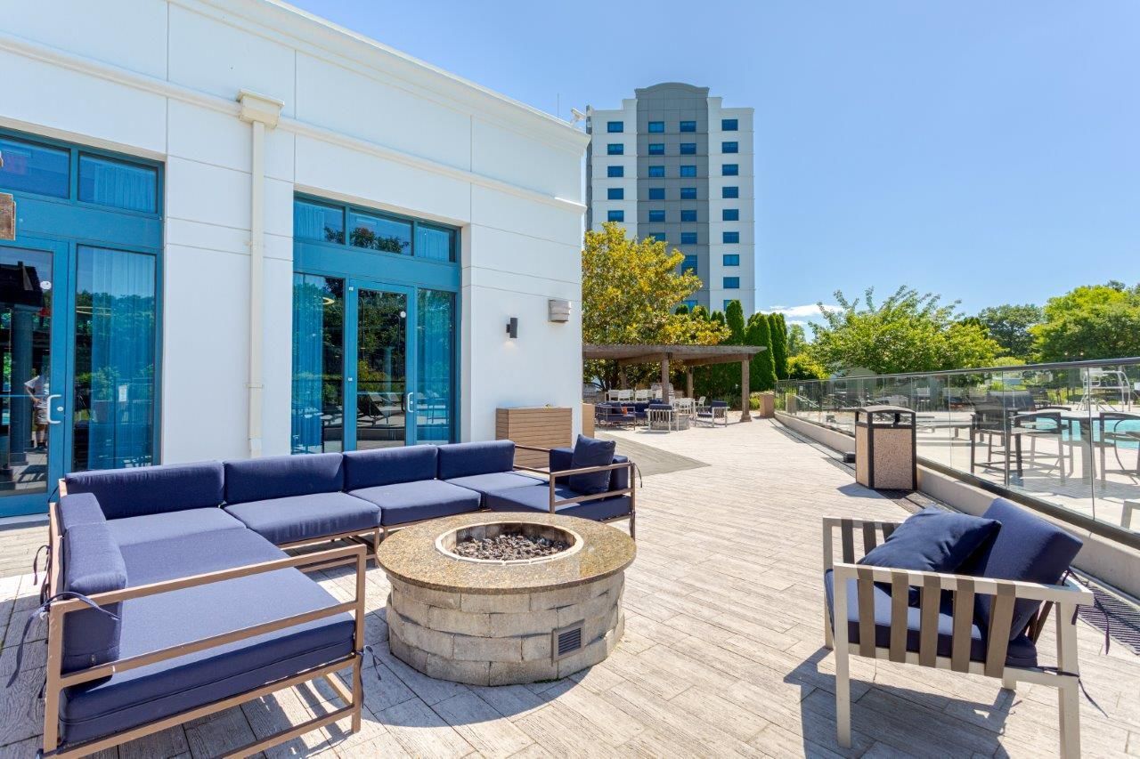 Outdoor patio with blue seating, fire pit