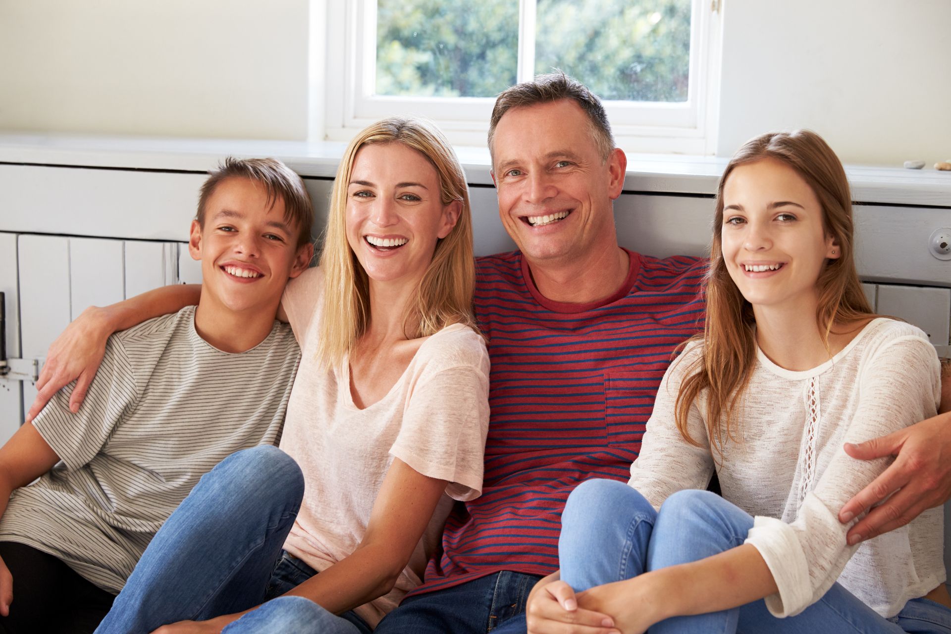 smileing family with three kids - receive family dental services in mobile al