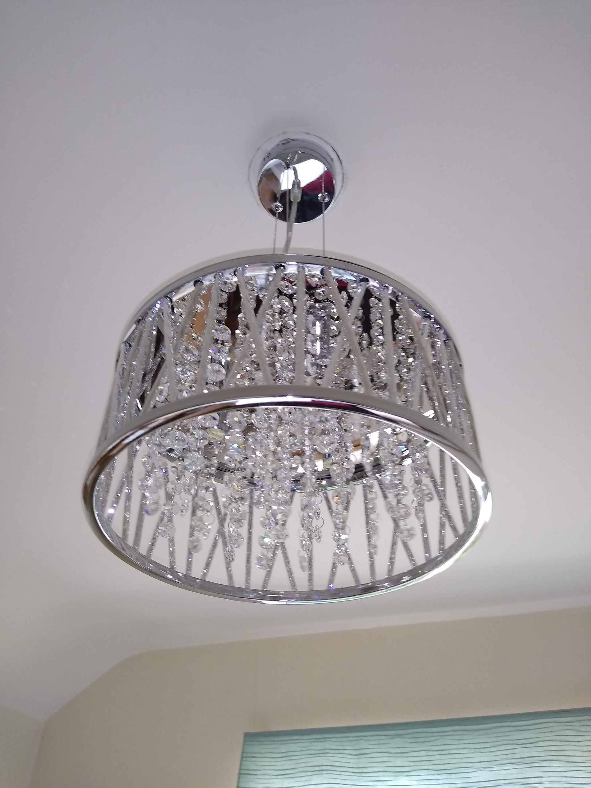Chrome light fitting installed in a bedroom in Redditch