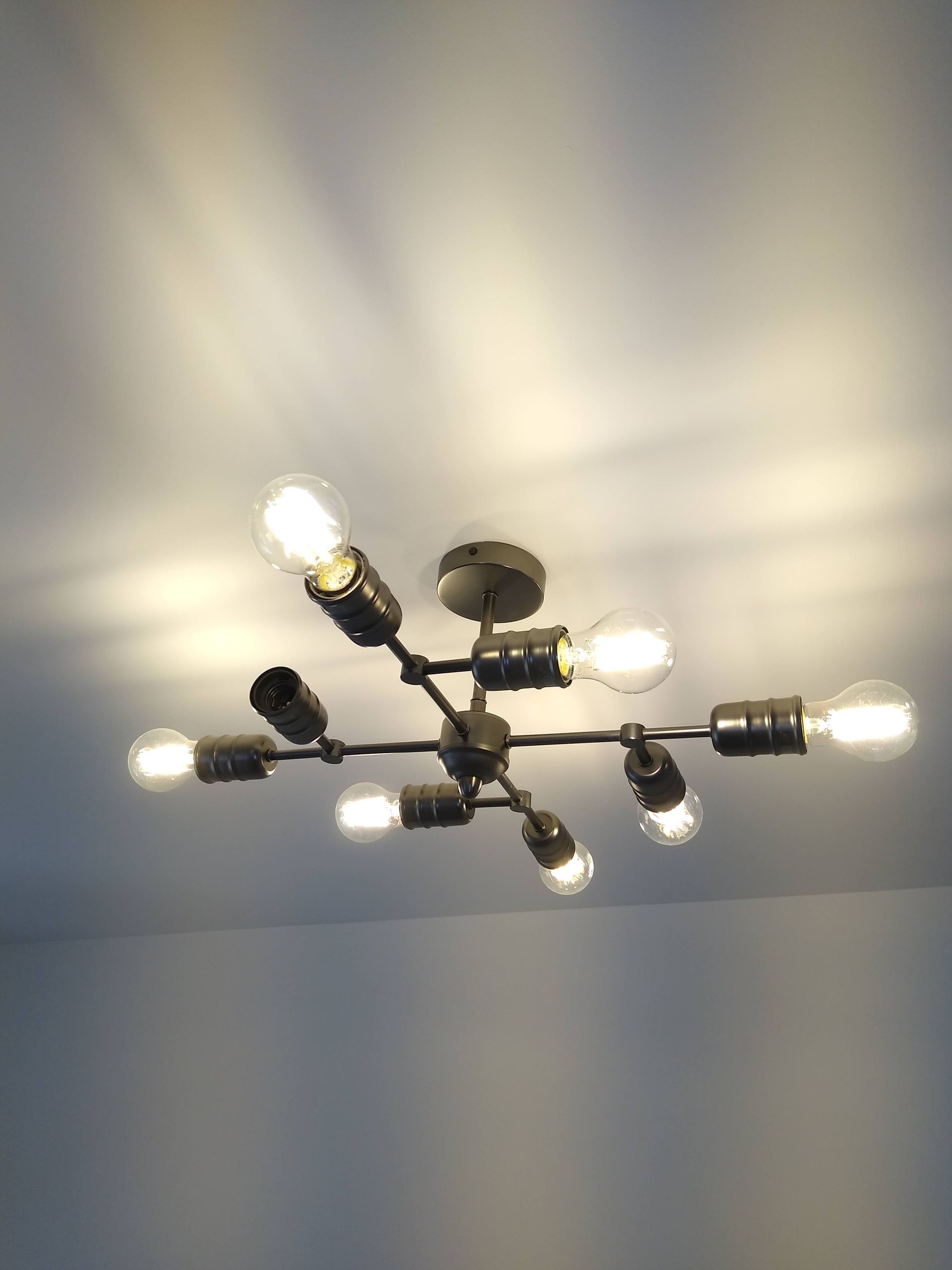 Decorative directional light fitting white background against ceiling