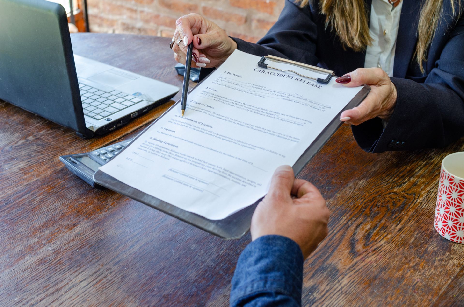 Approved Social Security Disability Claim — Sacramento, CA — Law Office of Barbara M. Jacobson Social Security Disability Lawyer reviewing a disability benefits claim with a client