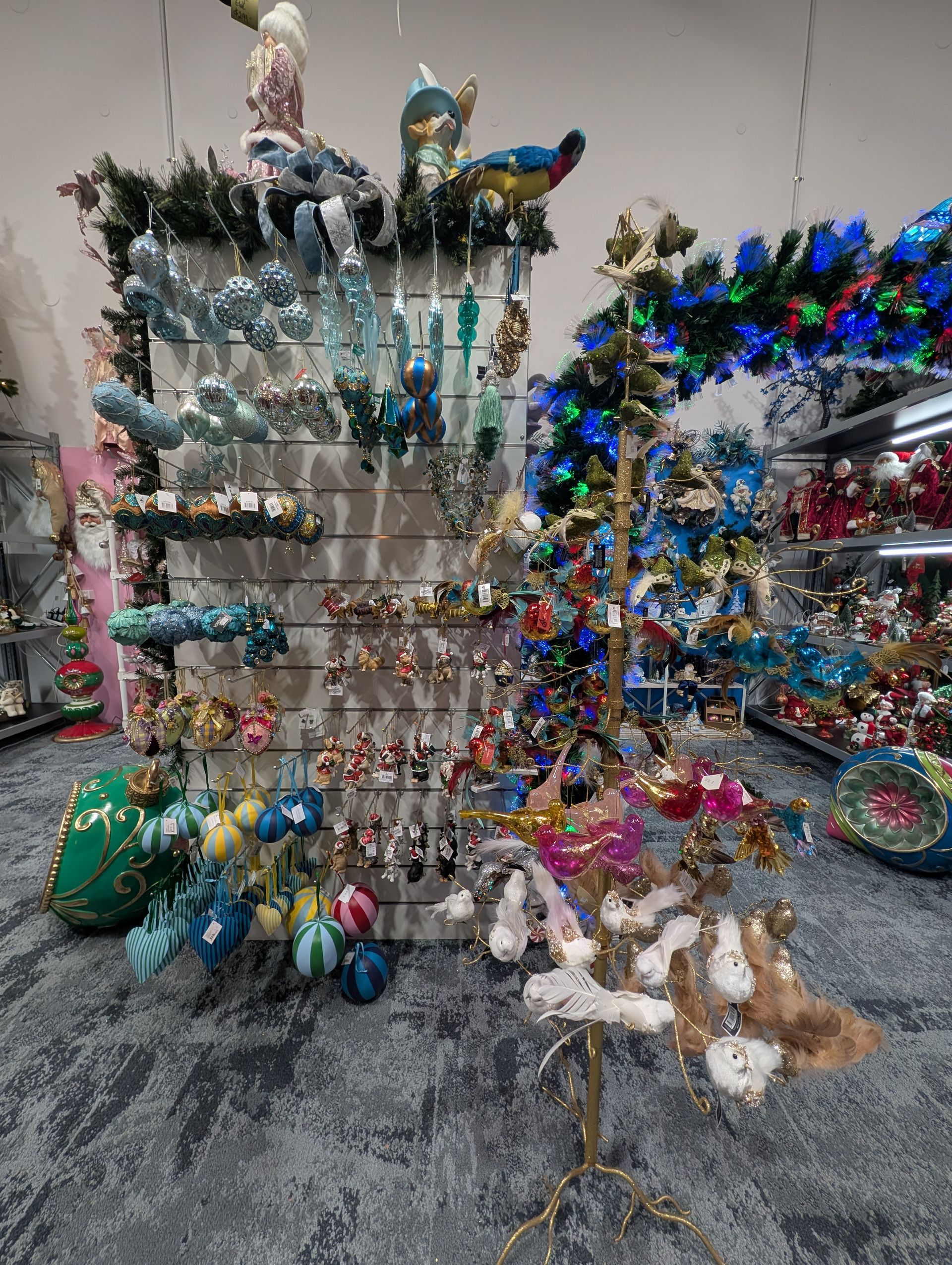 Display of Colorful Glass Birds and Ornaments on White Shelving in A Shop — Jingle Bell Christmas In Wollongbar, NSW