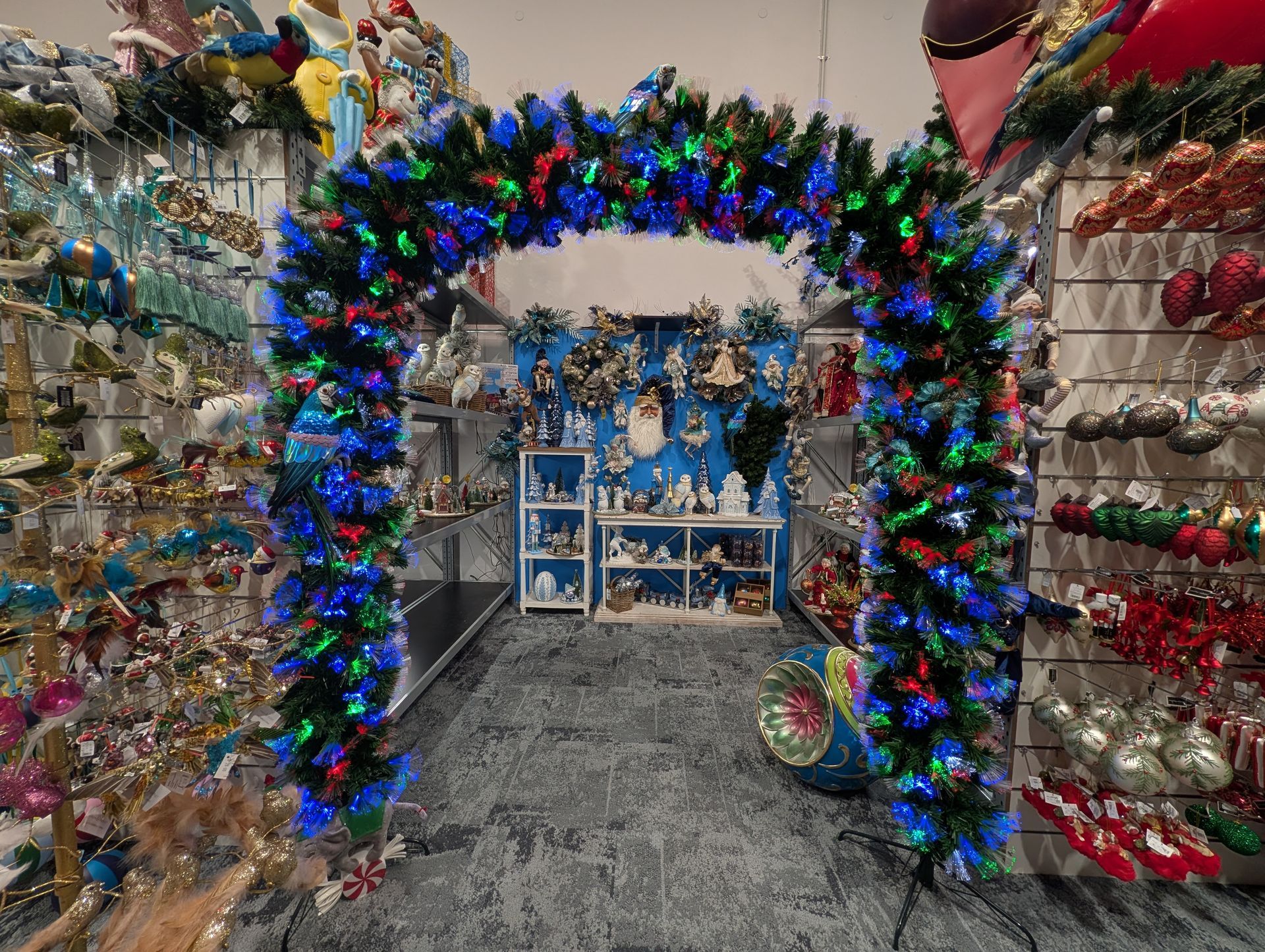 Holiday Aisle with A Lit Garland Arch and Shelves of Christmas Ornaments on Both Sides — Jingle Bell Christmas In Alstonville, NSW