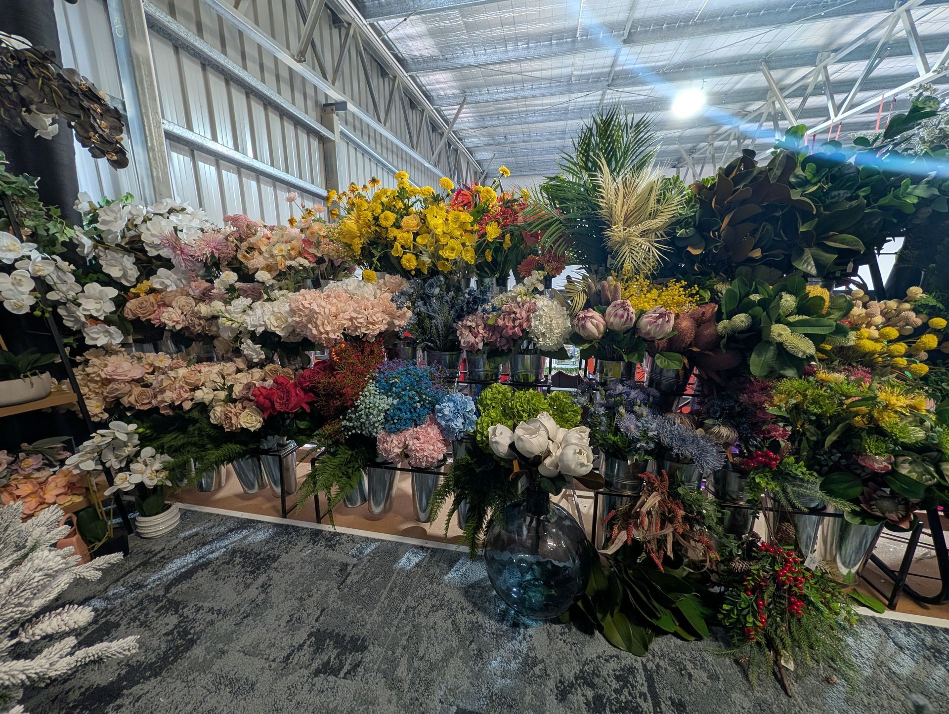 Indoor Flower Display with Rows of Colorful Bouquets and Greenery — Jingle Bell Christmas In Casino, NSW