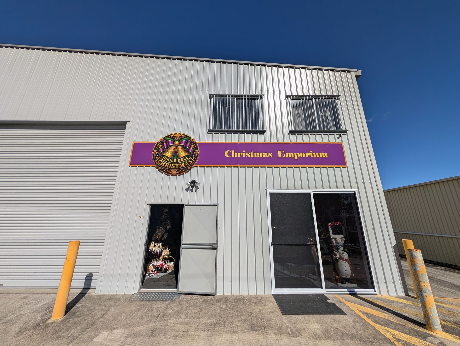 Exterior of A White Warehouse with A Purple “christian’s Emporium” Sign — Jingle Bell Christmas In Casino, NSW