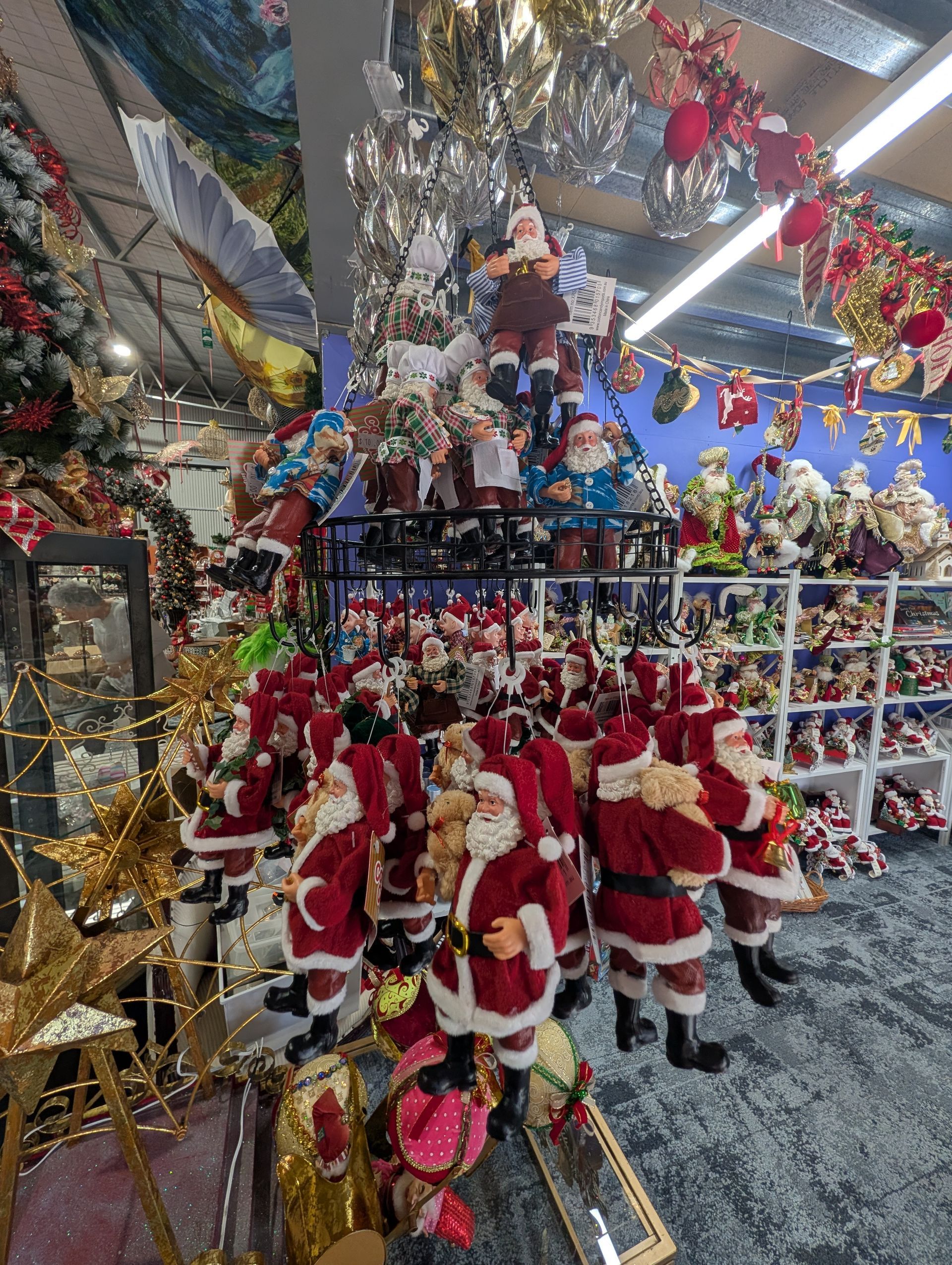 Christmas Shop Aisle Packed with Red Santa Figurines — Jingle Bell Christmas In Casino, NSW