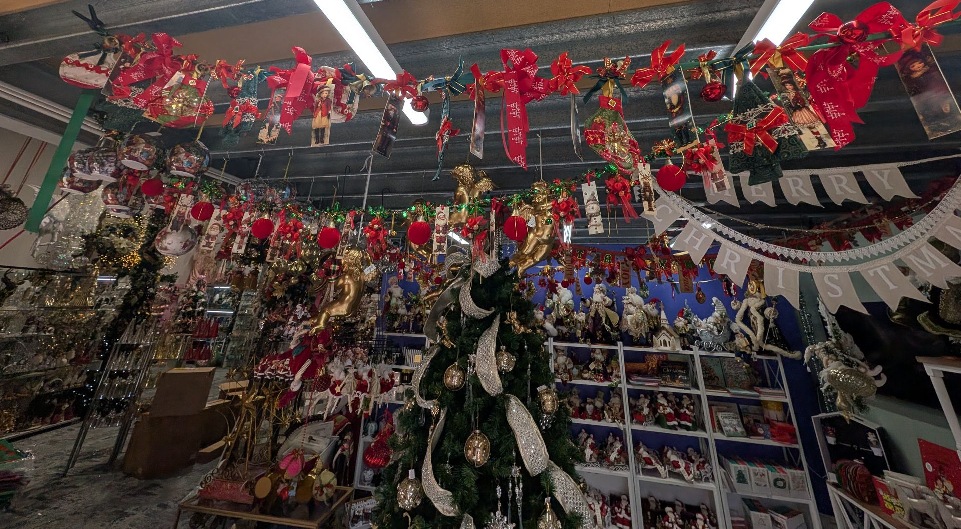 Holiday Store Aisle Decorated with Red Garlands — Jingle Bell Christmas In Casino, NSW