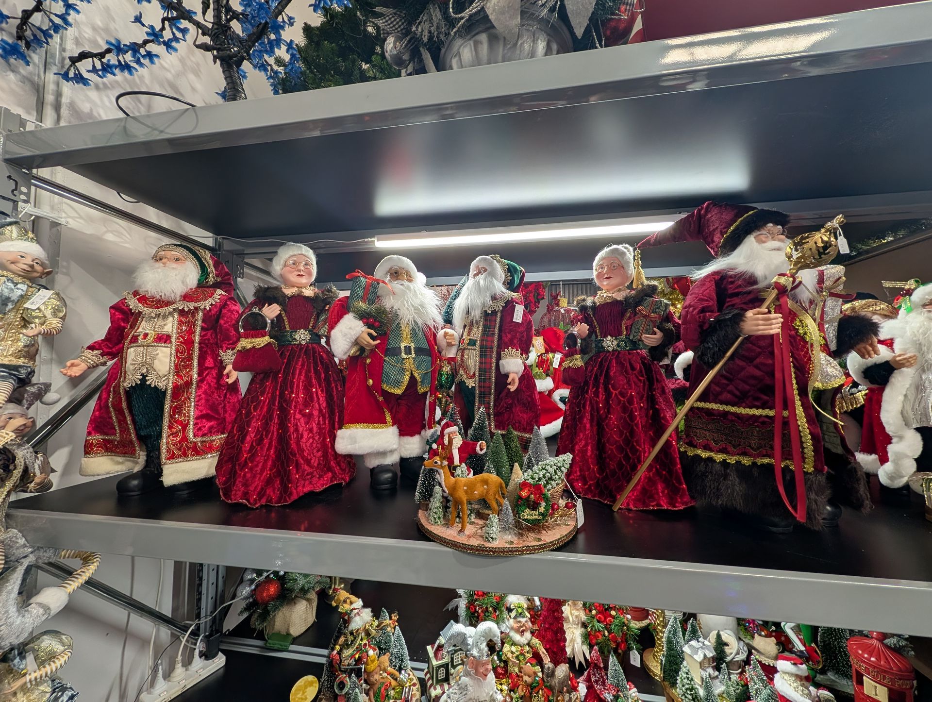 Shelf of Santa Claus Figurines in Red and Gold Holiday Outfits — Jingle Bell Christmas In Casino, NSW
