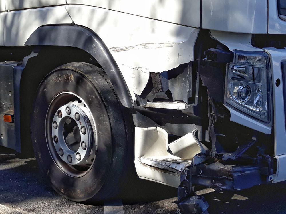 A White Truck With a Damaged Side is Parked on the Side of the Road — Vanderpoel Smash Repairs in Bateau Bay, NSW