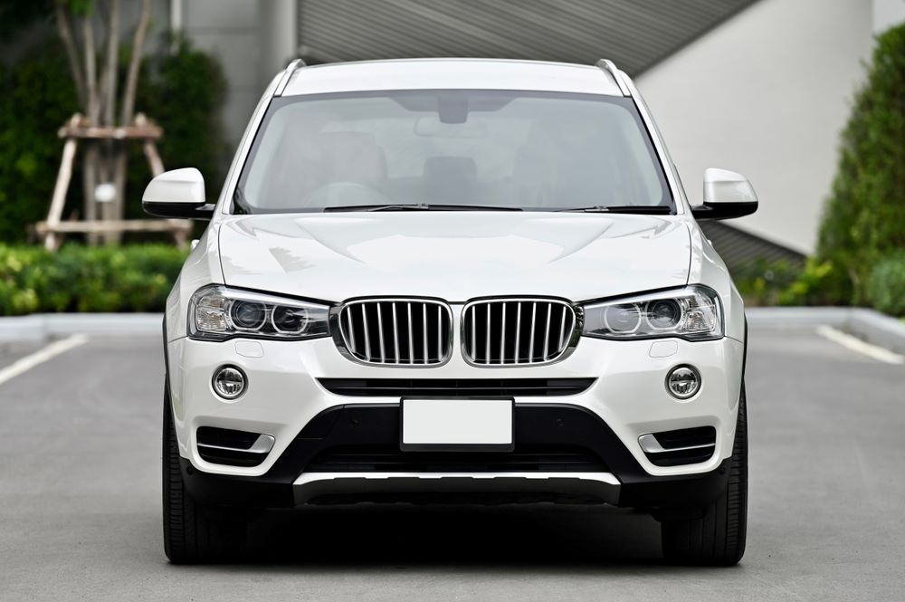 A White Bmw X3 is Parked on the Side of the Road — Vanderpoel Smash Repairs in Gosford, NSW
