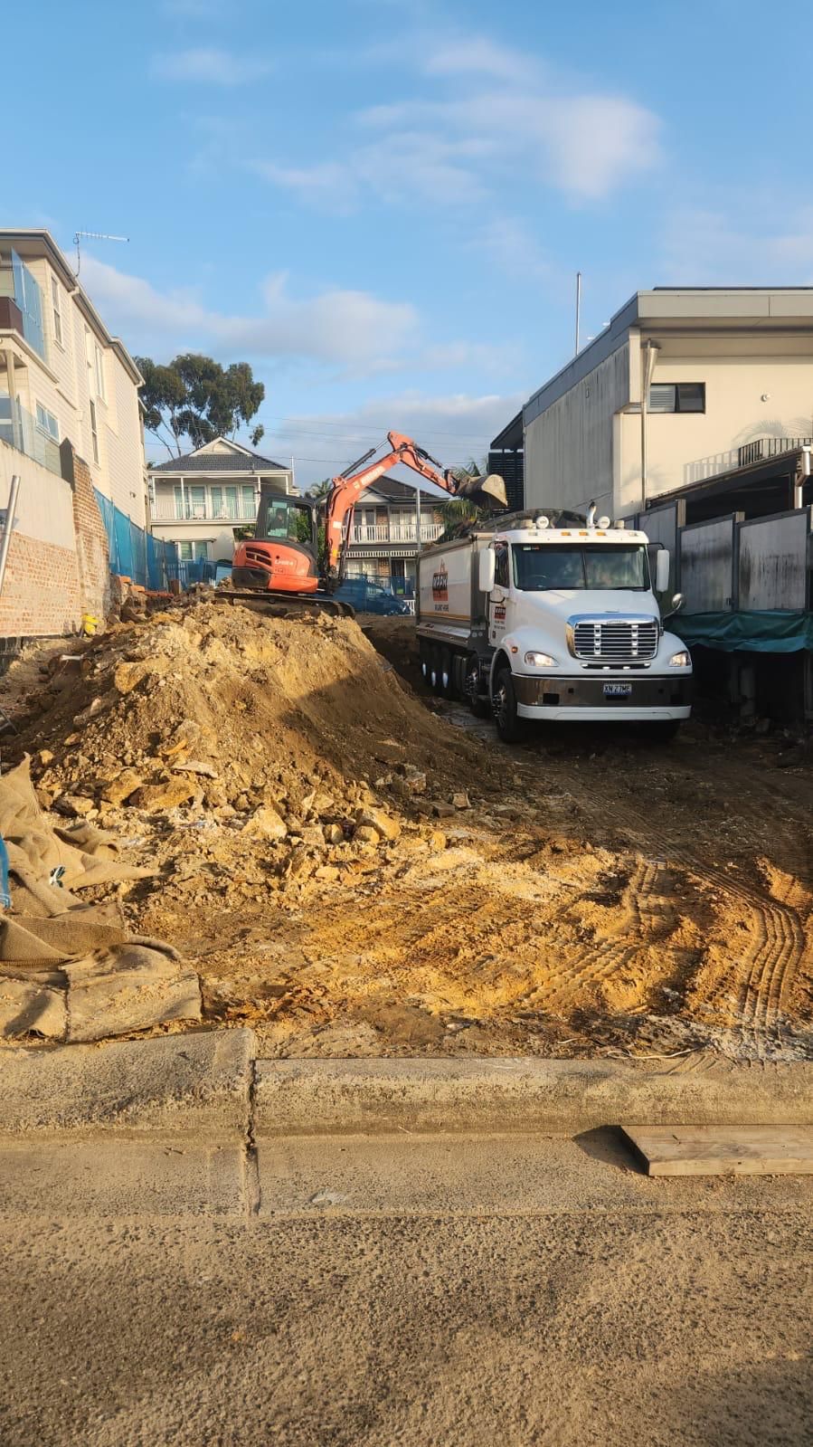 A truck is parked in front of a construction site.