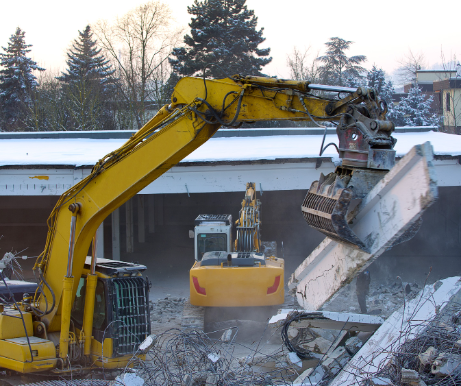 A yellow excavator is working on a construction site
