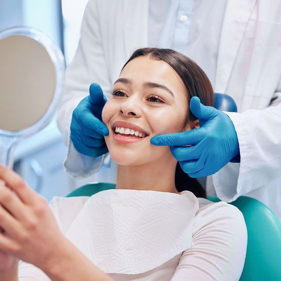 Dentist examining patient's smile