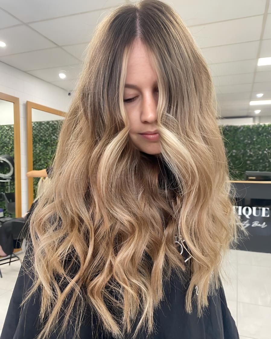 A Woman With Long Blonde Hair — Beautique Hair Lounge & Beauty Bar In Condon, QLD