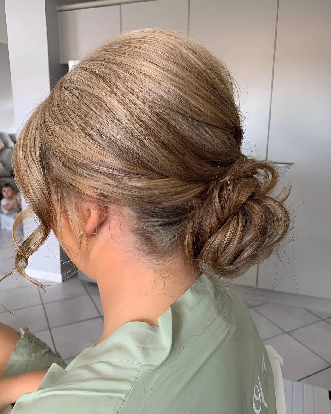 A Woman With Her Hair In A Bun — Beautique Hair Lounge & Beauty Bar In Condon, QLD