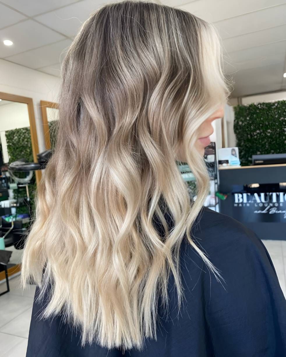 A Woman With Long Blonde Hair — Beautique Hair Lounge & Beauty Bar In Rasmussen, QLD
