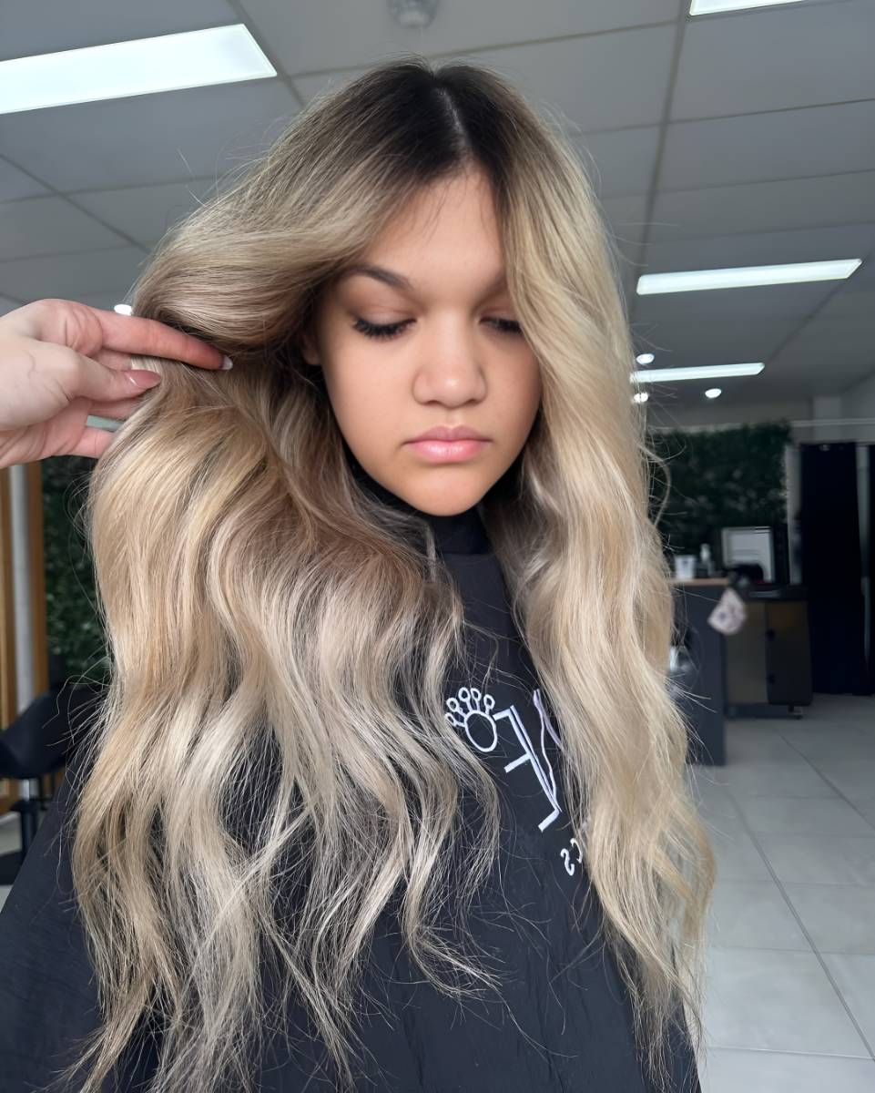 A Woman With Long Blonde Hair Is Getting Her Hair Cut — Beautique Hair Lounge & Beauty Bar In Condon, QLD