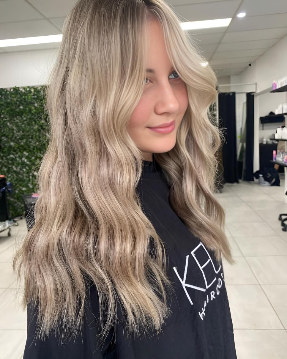 A Woman With Long Blonde Hair Is Wearing A Black — Beautique Hair Lounge & Beauty Bar In Condon, QLD