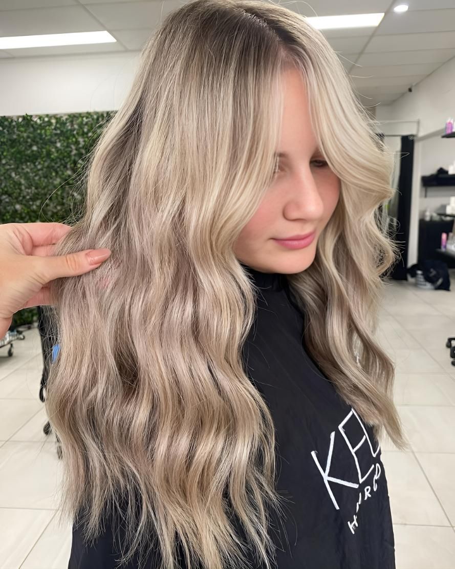 A Woman With Long Blonde Hair Is Getting Her Hair Cut — Beautique Hair Lounge & Beauty Bar In Condon, QLD