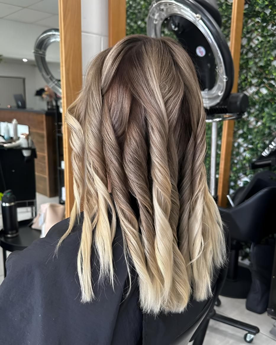 A Woman Is Getting Her Hair Done — Beautique Hair Lounge & Beauty Bar In Condon, QLD