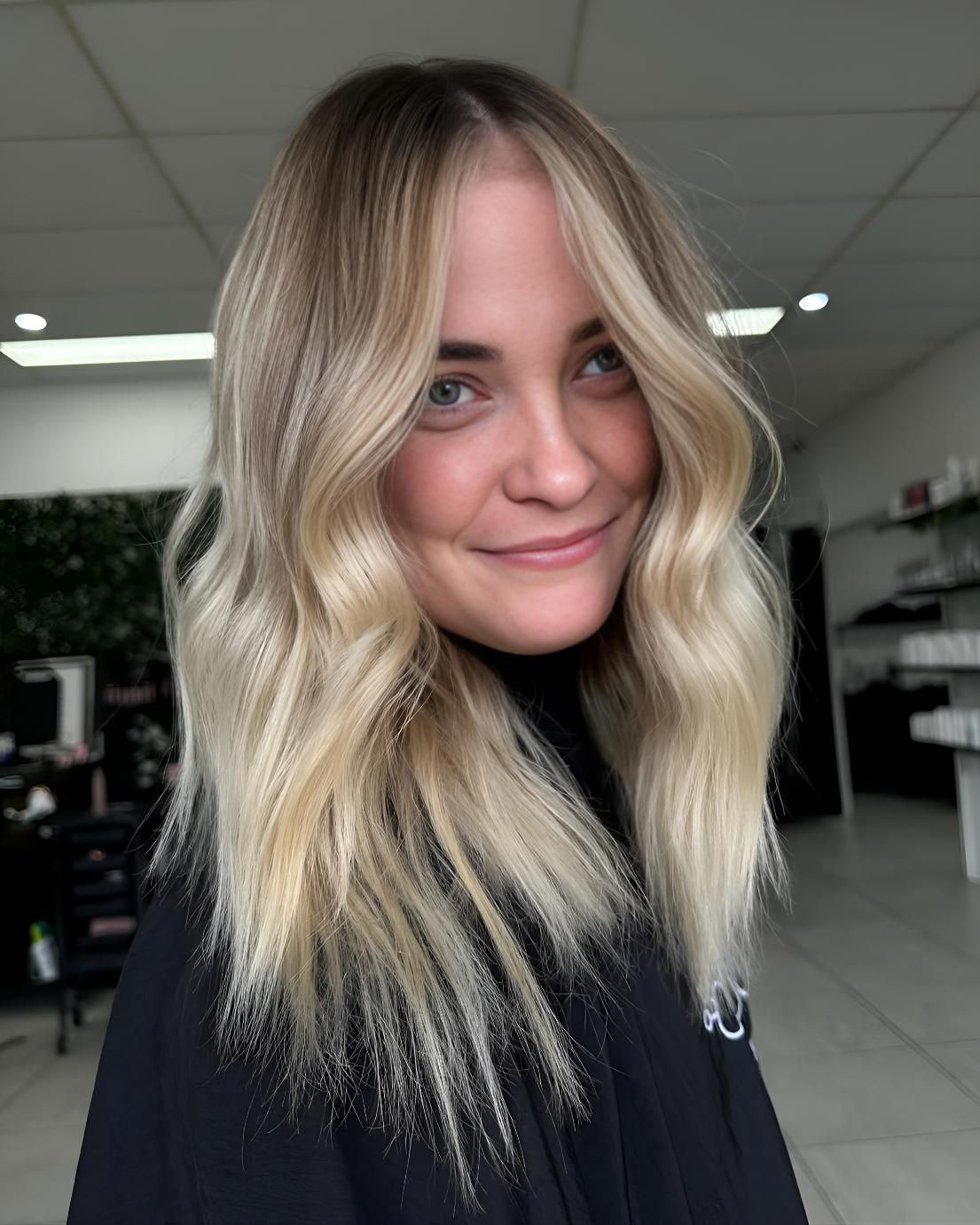 A Woman With Blonde Hair Is Smiling — Beautique Hair Lounge & Beauty Bar In Condon, QLD