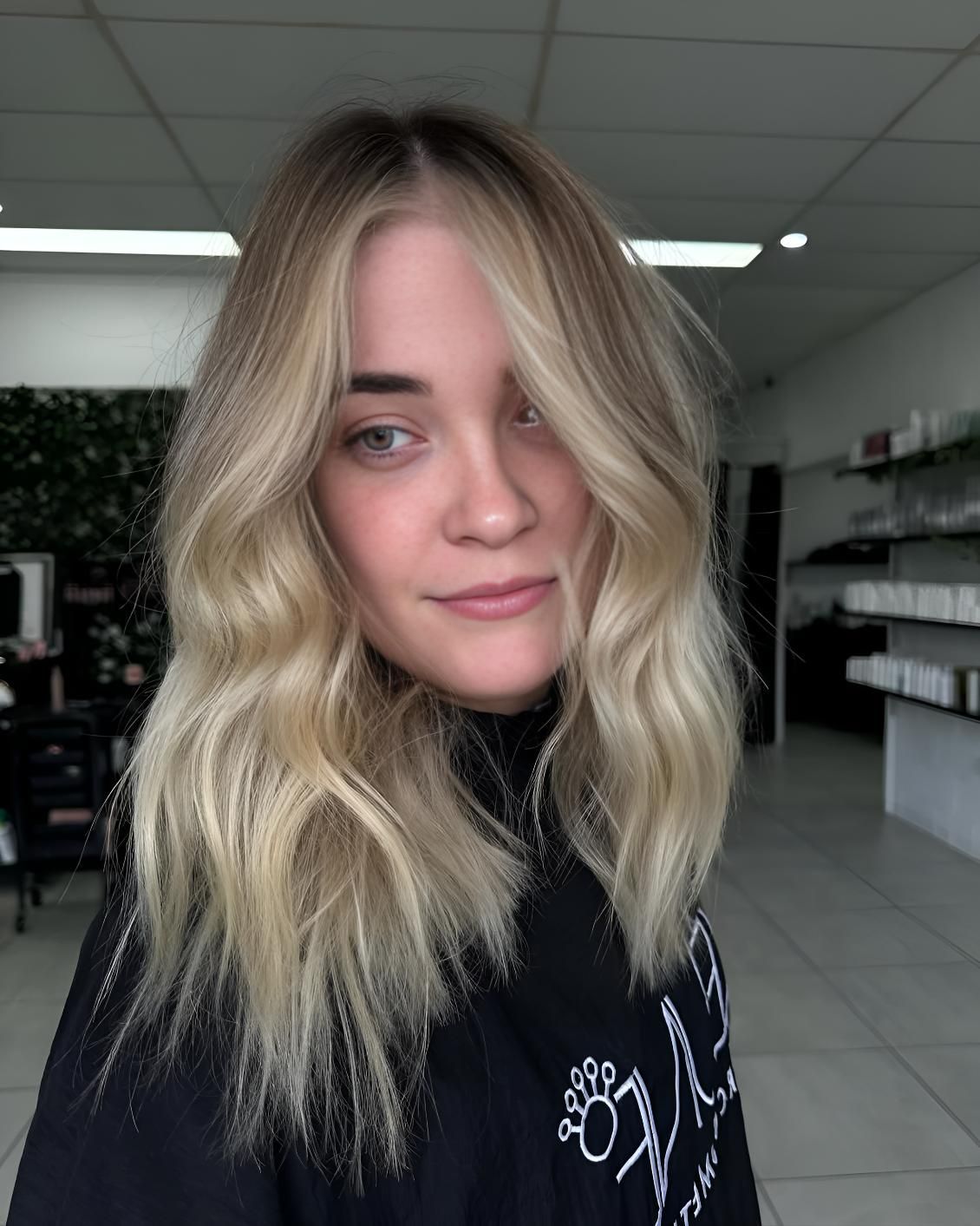 A Woman With Blonde Hair And A Black Shirt — Beautique Hair Lounge & Beauty Bar In Condon, QLD