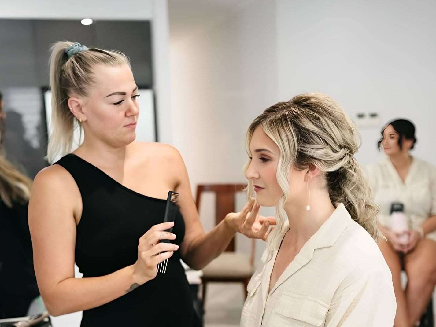 A Woman Is Getting Her Makeup Done — Beautique Hair Lounge & Beauty Bar In Condon, QLD