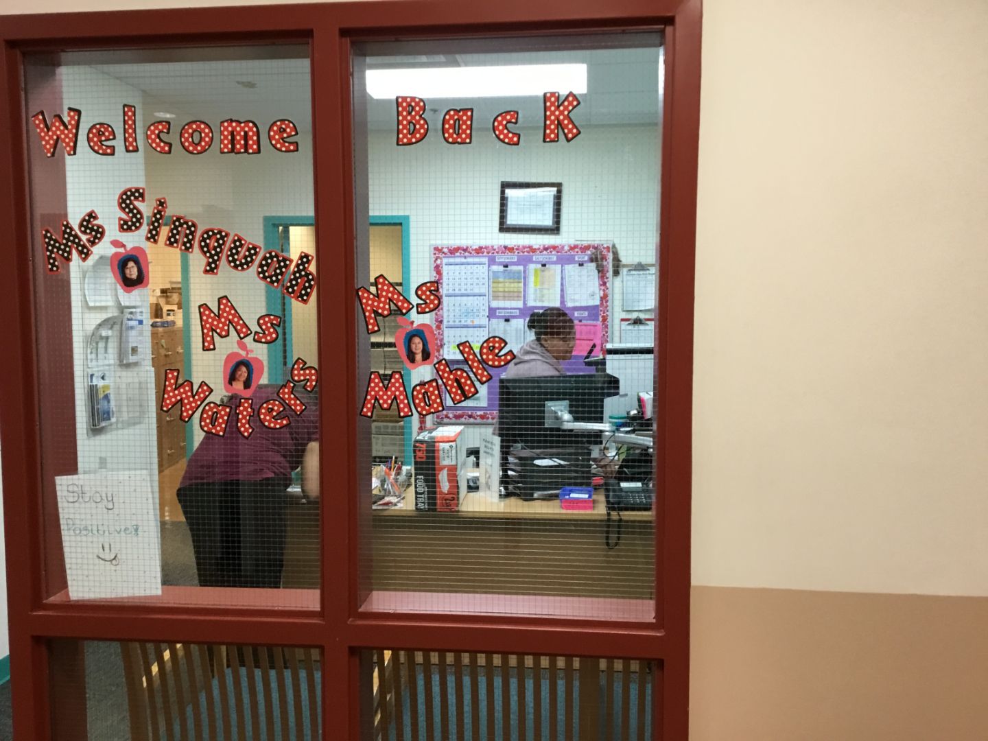 A window with welcome back written on it