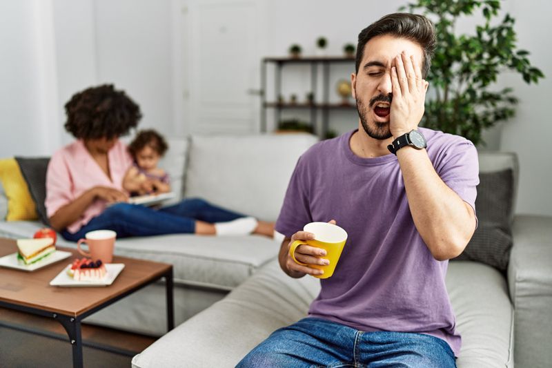 Man Is Yawning While Holding A Cup Of Coffee - Indianapolis, IN - Sleep Better Indy Man Is Yawning While Holding A Cup Of Coffee - Indianapolis, IN - Sleep Better Indy