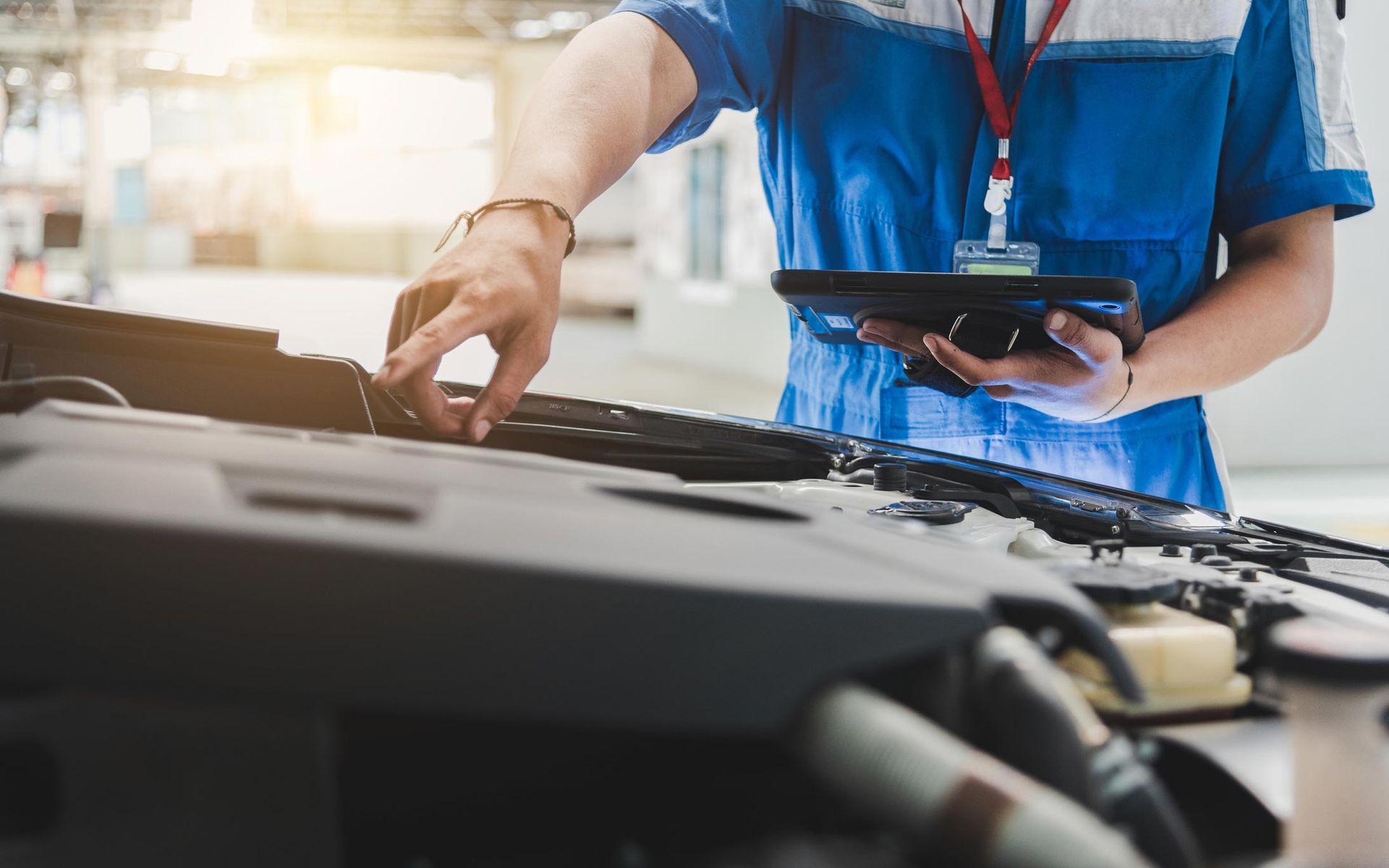 Auto Mechanic Uses The Tablet To Check — Justin, TX — Auto Revival Auto Mechanic Uses The Tablet To Check — Justin, TX — Auto Revival
