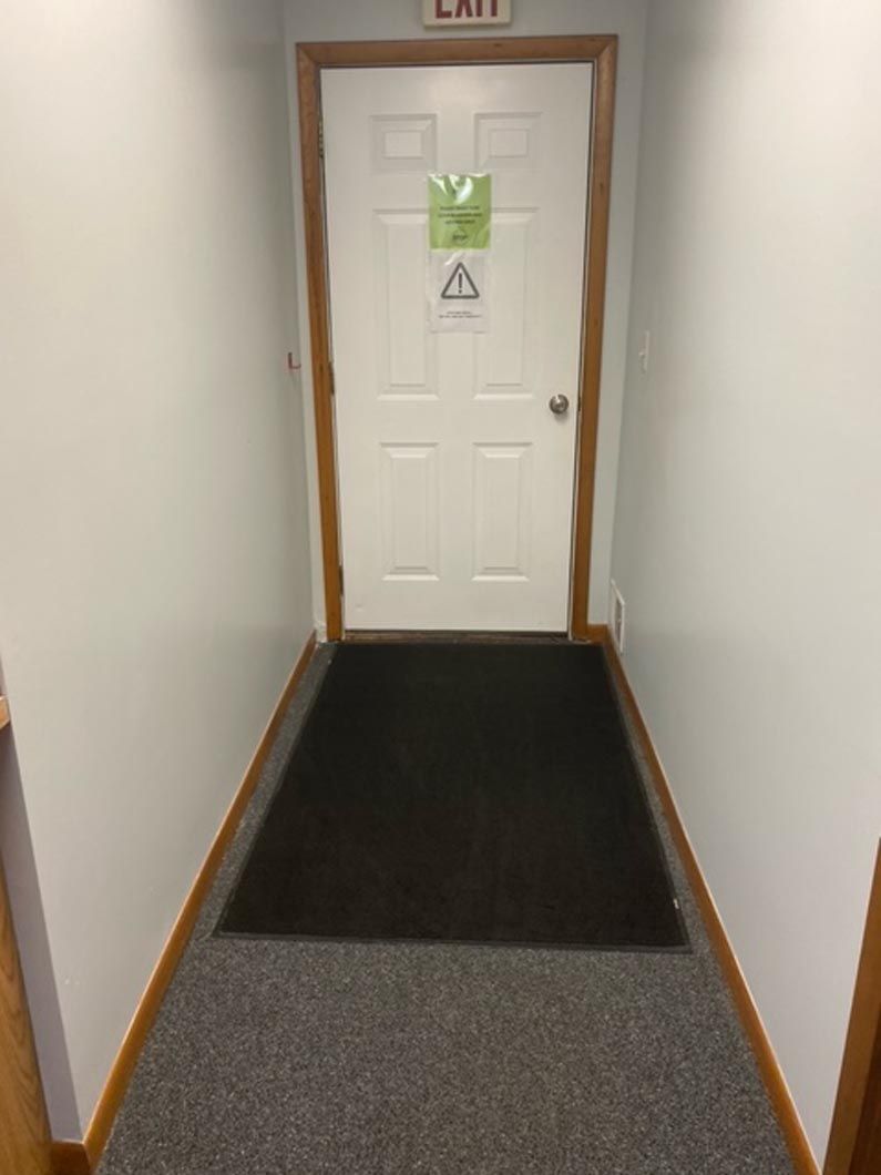 A white door labeled 
