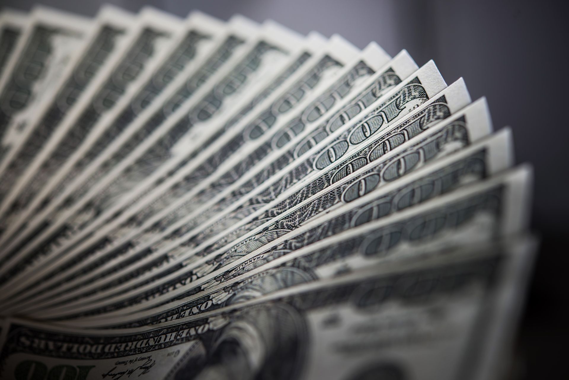 Fan of US $100 bills; green and white.
