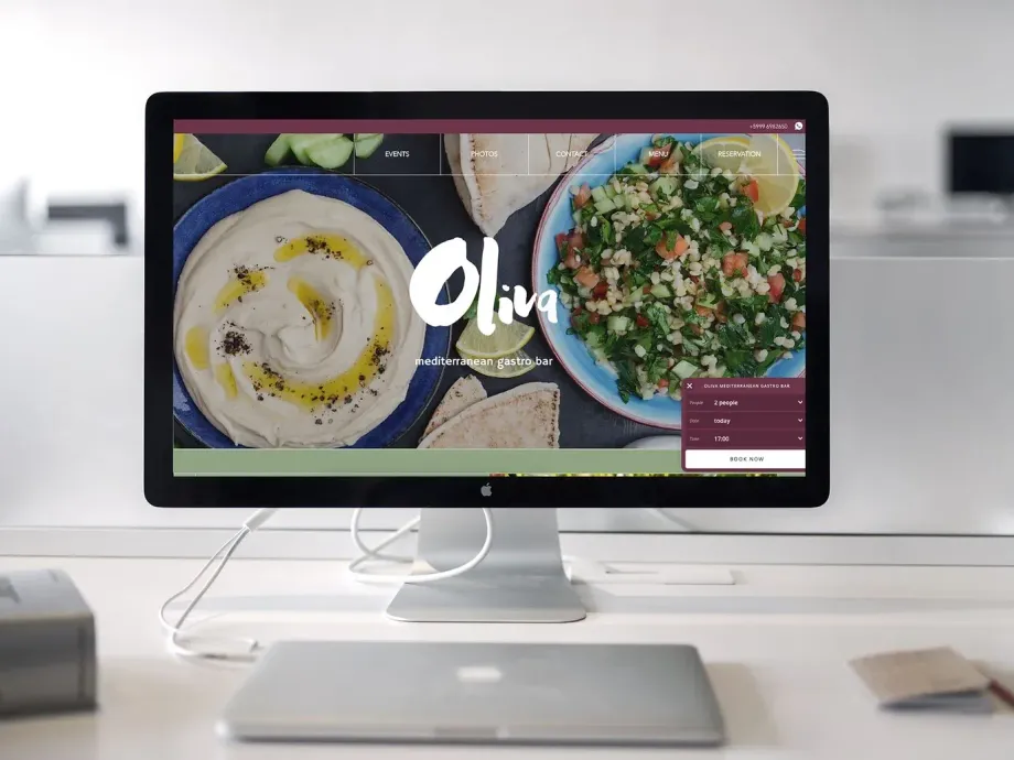 A computer monitor with beautiful website of a restaurant