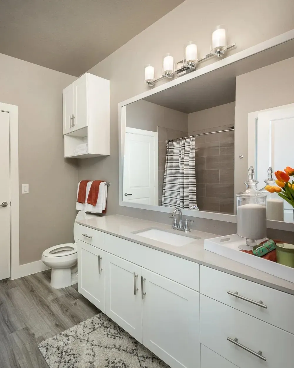 Modern bathroom with white cabinets and a mirror