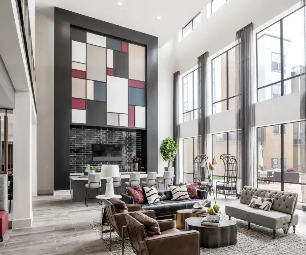 Modern community lounge with large windows and contemporary furniture