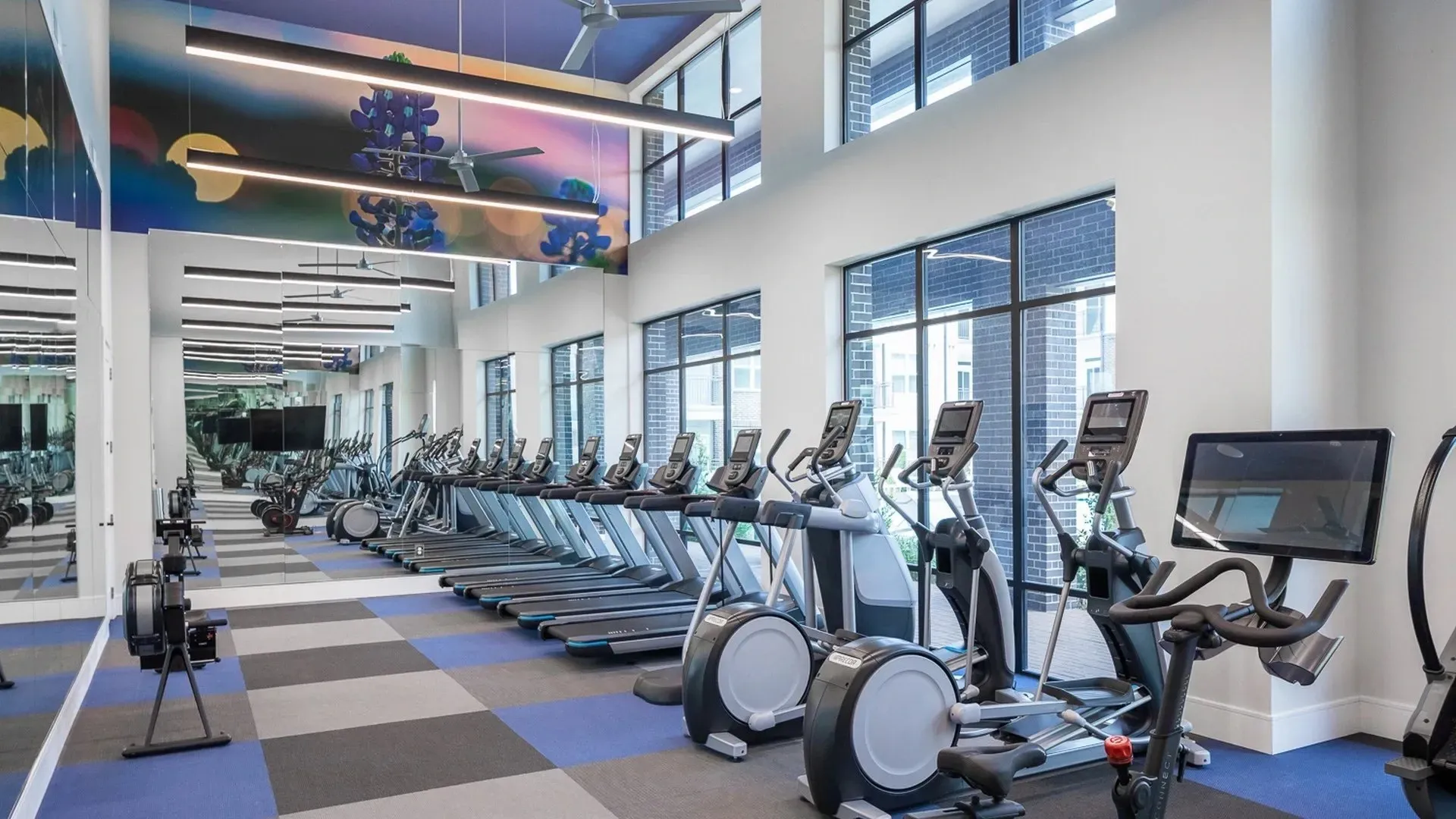 Bright and spacious fitness center with exercise equipment and natural light.